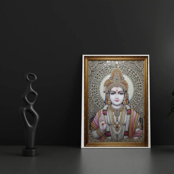 Invite the auspicious presence of Lord Rama into your home with this exquisite, jewel-embellished artwork. Portrayed with a calm and compassionate demeanor, Lord Rama's divine form is adorned with a resplendent crown, intricate necklaces, and garlands of flowers, all brought to life with shimmering crystals and detailed artistry. His right hand is raised in the Abhaya Mudra, offering reassurance and dispelling fears. The radiant halo behind him signifies his divine light and purity. This sacred piece is ideal for your puja room, meditation space, or living area, serving as a constant source of inspiration, peace, and protection for your family.