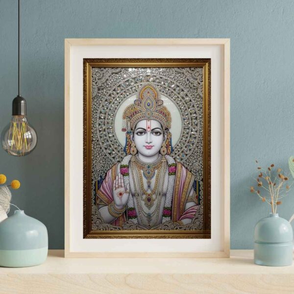 Invite the auspicious presence of Lord Rama into your home with this exquisite, jewel-embellished artwork. Portrayed with a calm and compassionate demeanor, Lord Rama's divine form is adorned with a resplendent crown, intricate necklaces, and garlands of flowers, all brought to life with shimmering crystals and detailed artistry. His right hand is raised in the Abhaya Mudra, offering reassurance and dispelling fears. The radiant halo behind him signifies his divine light and purity. This sacred piece is ideal for your puja room, meditation space, or living area, serving as a constant source of inspiration, peace, and protection for your family.